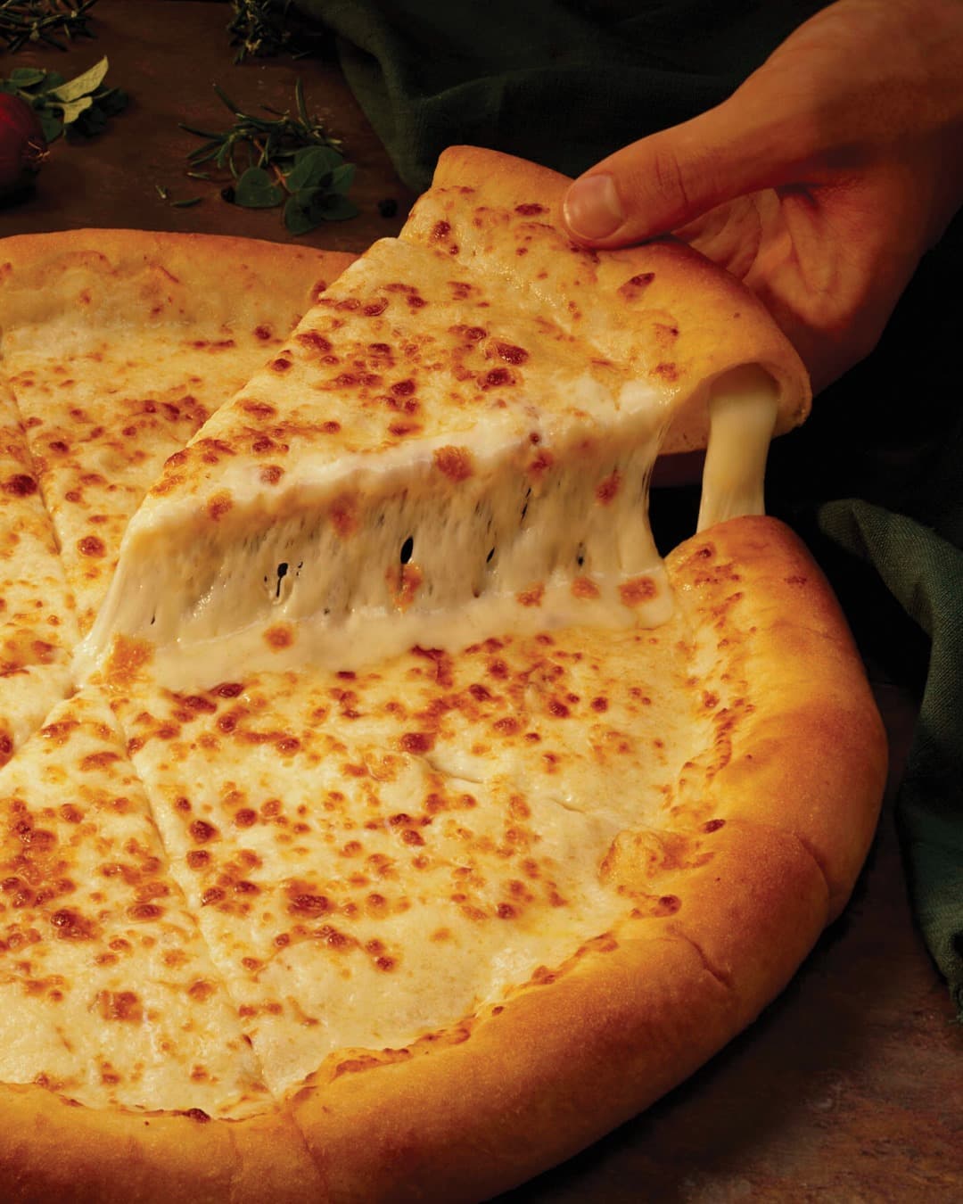 Apache Pizza freshly baked pizza with toppings in restaurant setting