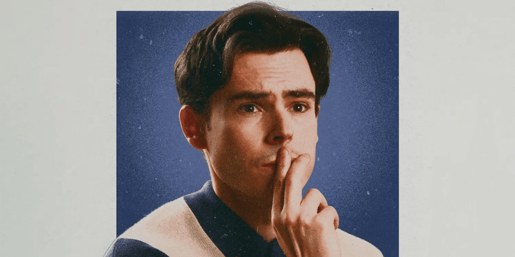 Rhys James male comedian resting chin on hand thoughtful close-up portrait