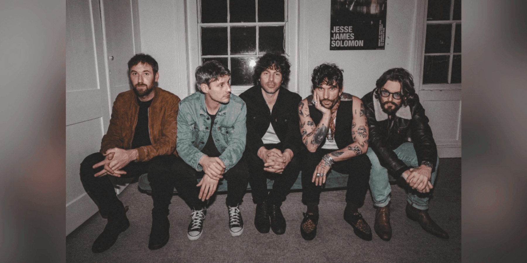 Small Fortunes band group photo with multiple members in muted tones