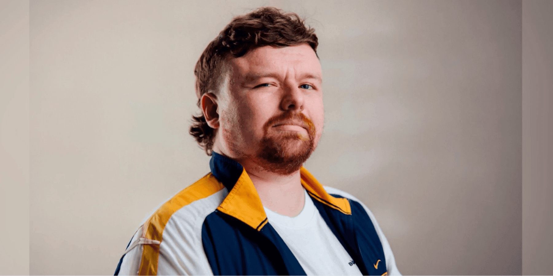 Aaron McCann male musician in dramatic orange and amber warm lighting close-up portrait