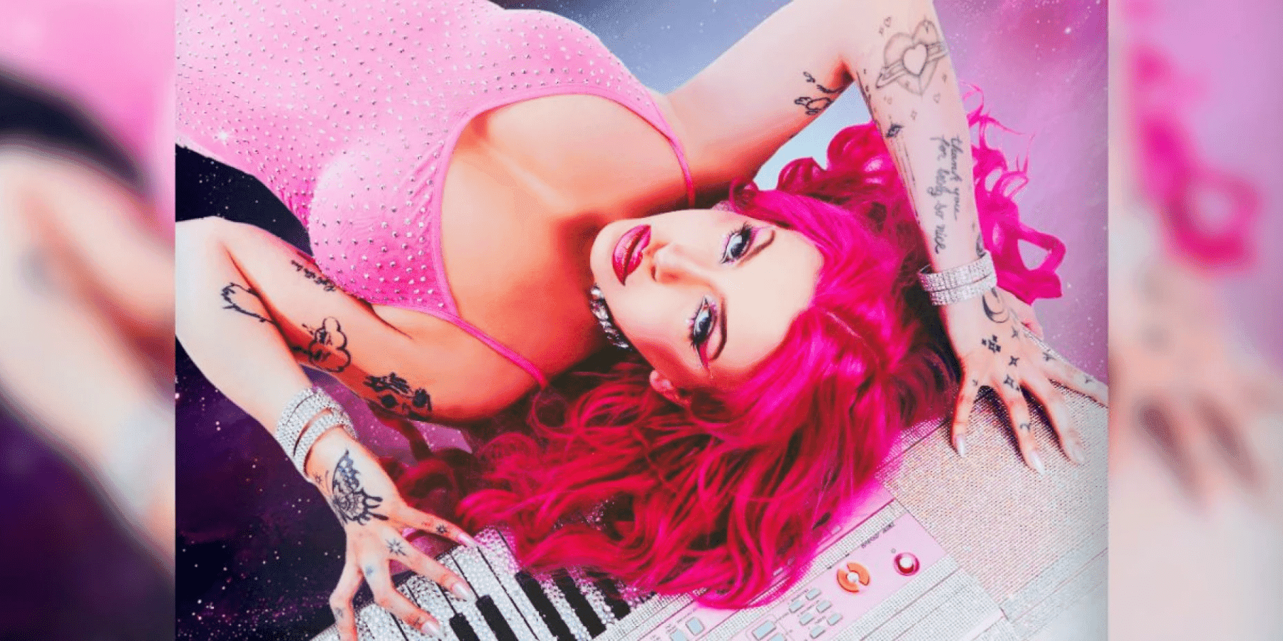Chrissy Chlapecka female performer with pink hair in glamorous reclined portrait