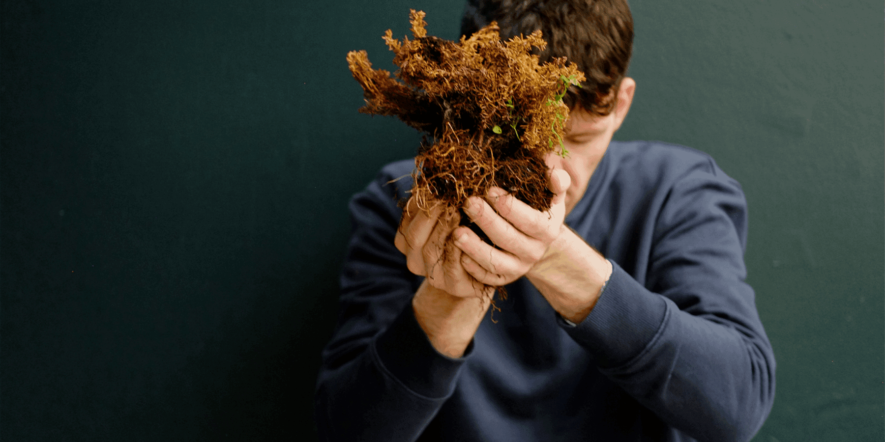 Distillation person holding bundle of dried wildflowers close-up portrait