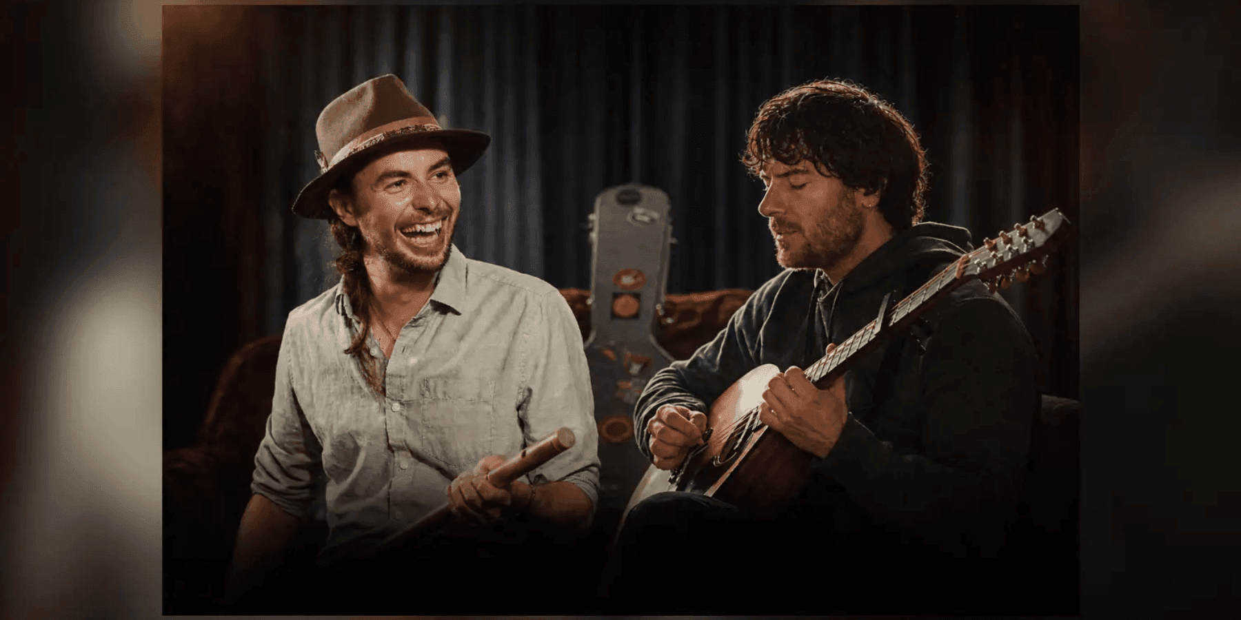 Rennie and Lúan two musicians performing together with instruments on stage