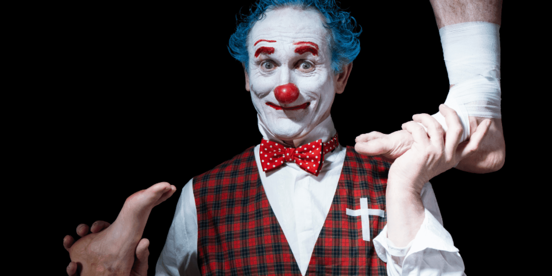 Welcome to Traumatraum clown performer in red bow tie theatrical portrait