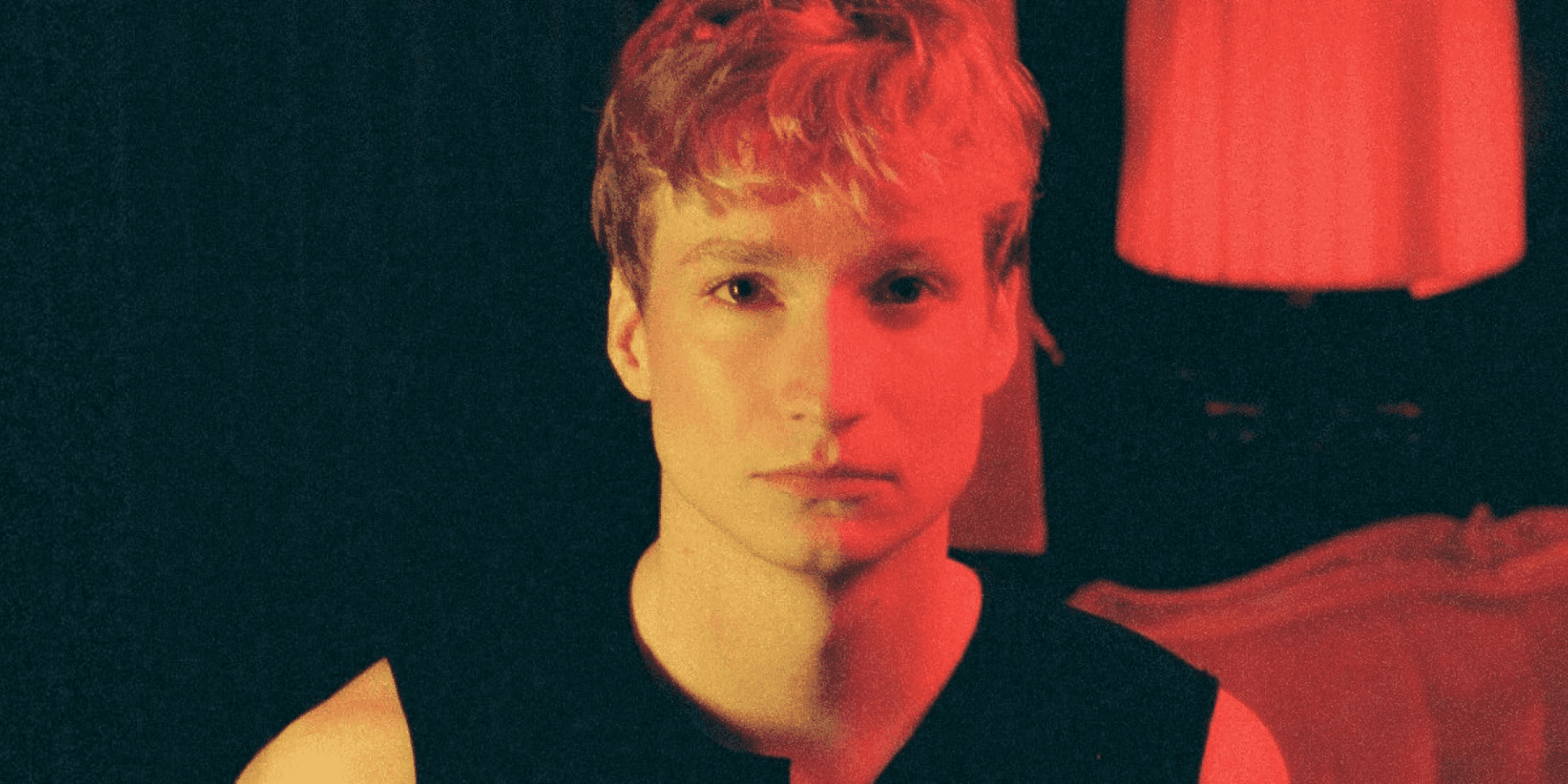 Kevin Atwater male musician in dramatic red stage lighting close-up portrait