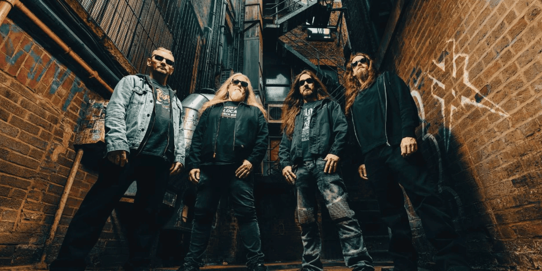 Xentrix band members in dark clothing moody group photo